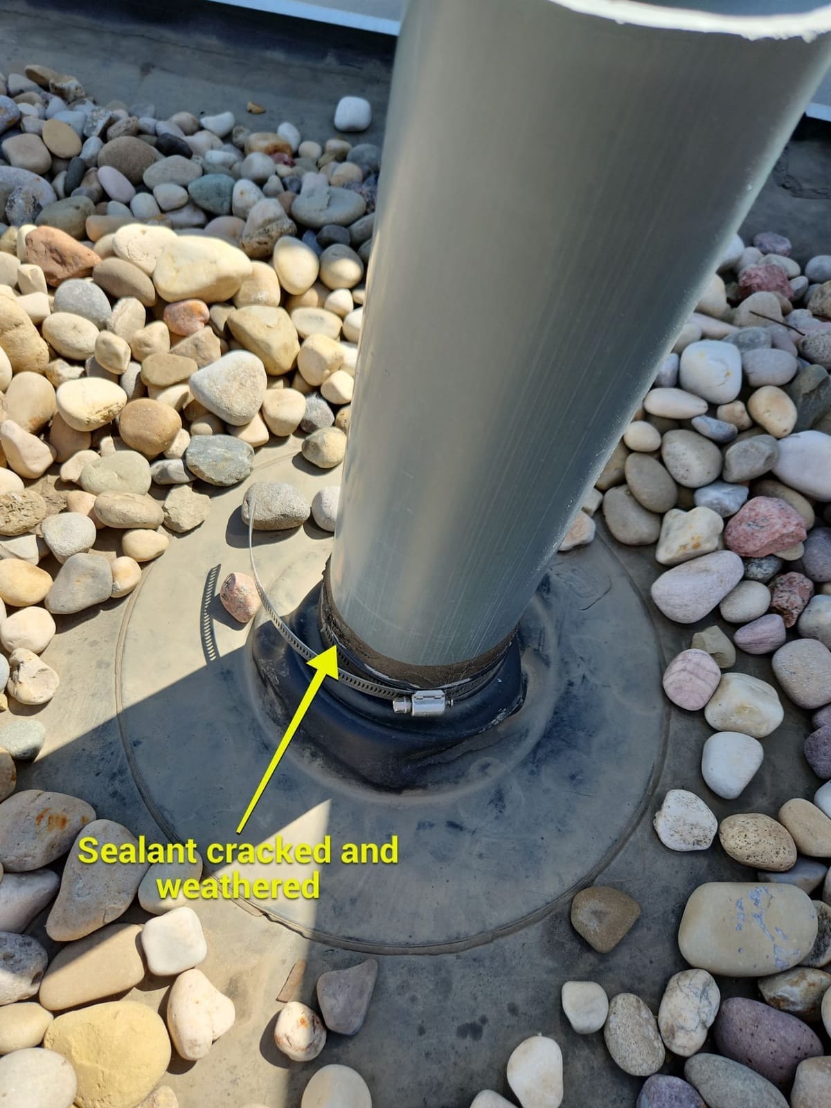 Failed sealant to plumbing boot on a flat roof