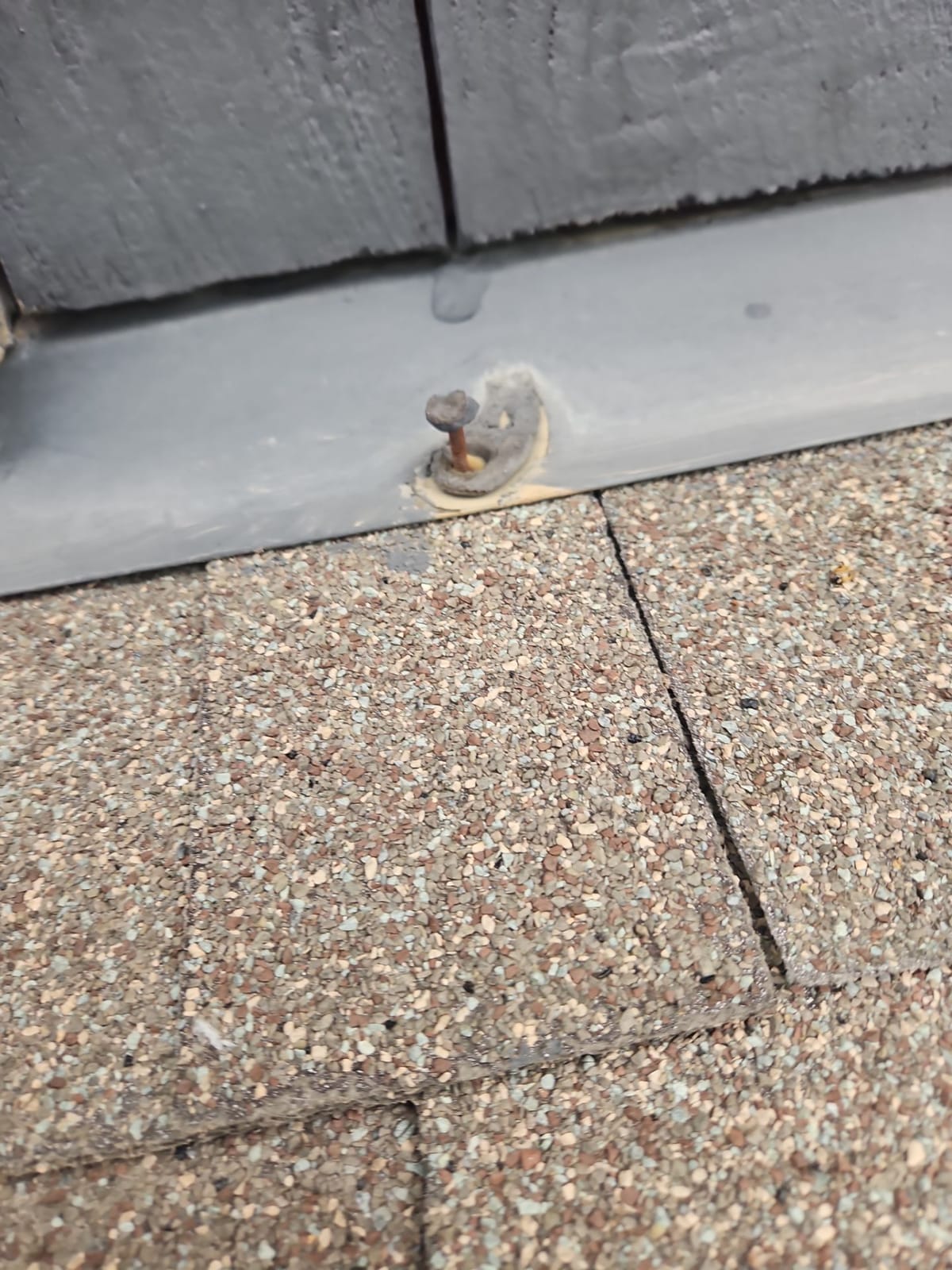 Detached rusted fastener with time to wall flashing
