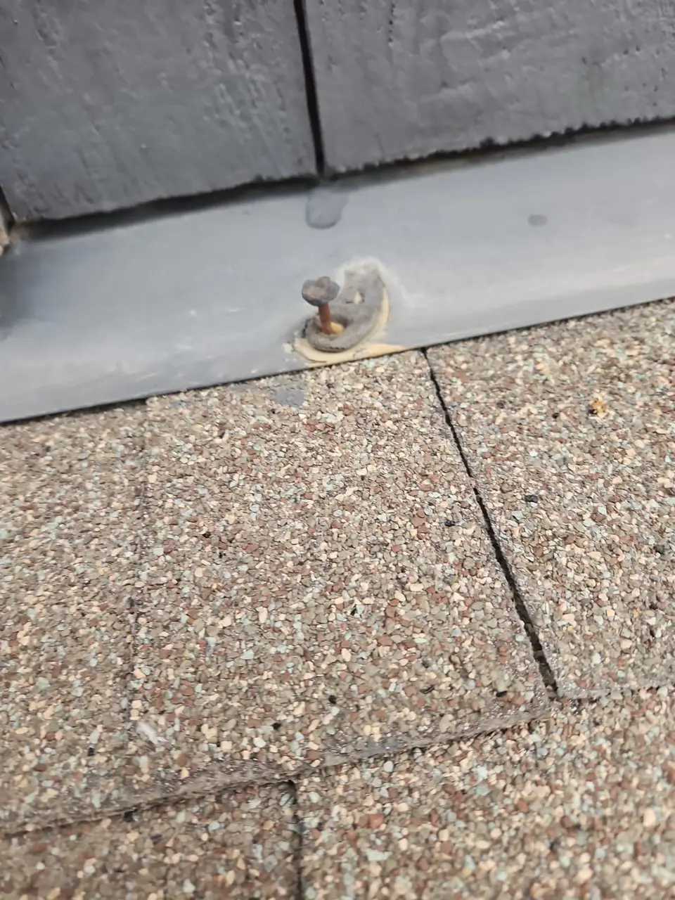 Detached rusted fastener with time to wall flashing