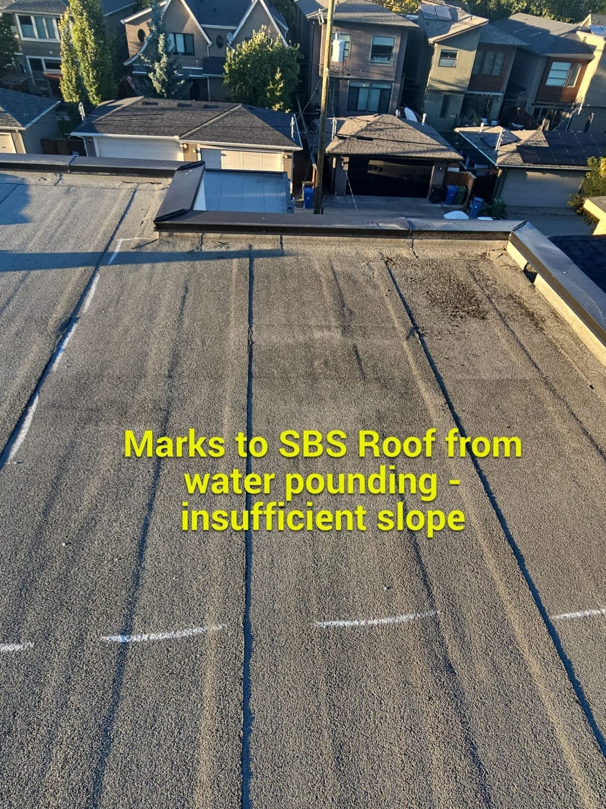 water stain damage to sbs roof from pounding water caused by bad drain