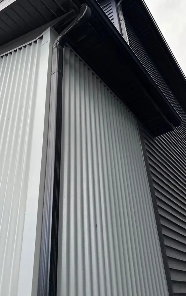 black-eaves-installed-contrast-corrogated-metal-sidingpanel