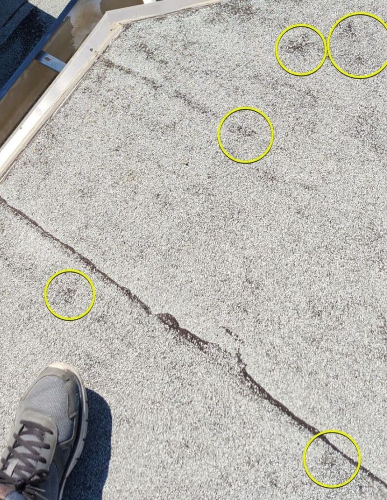 Rough circular shapes of hail hits to torched down roof