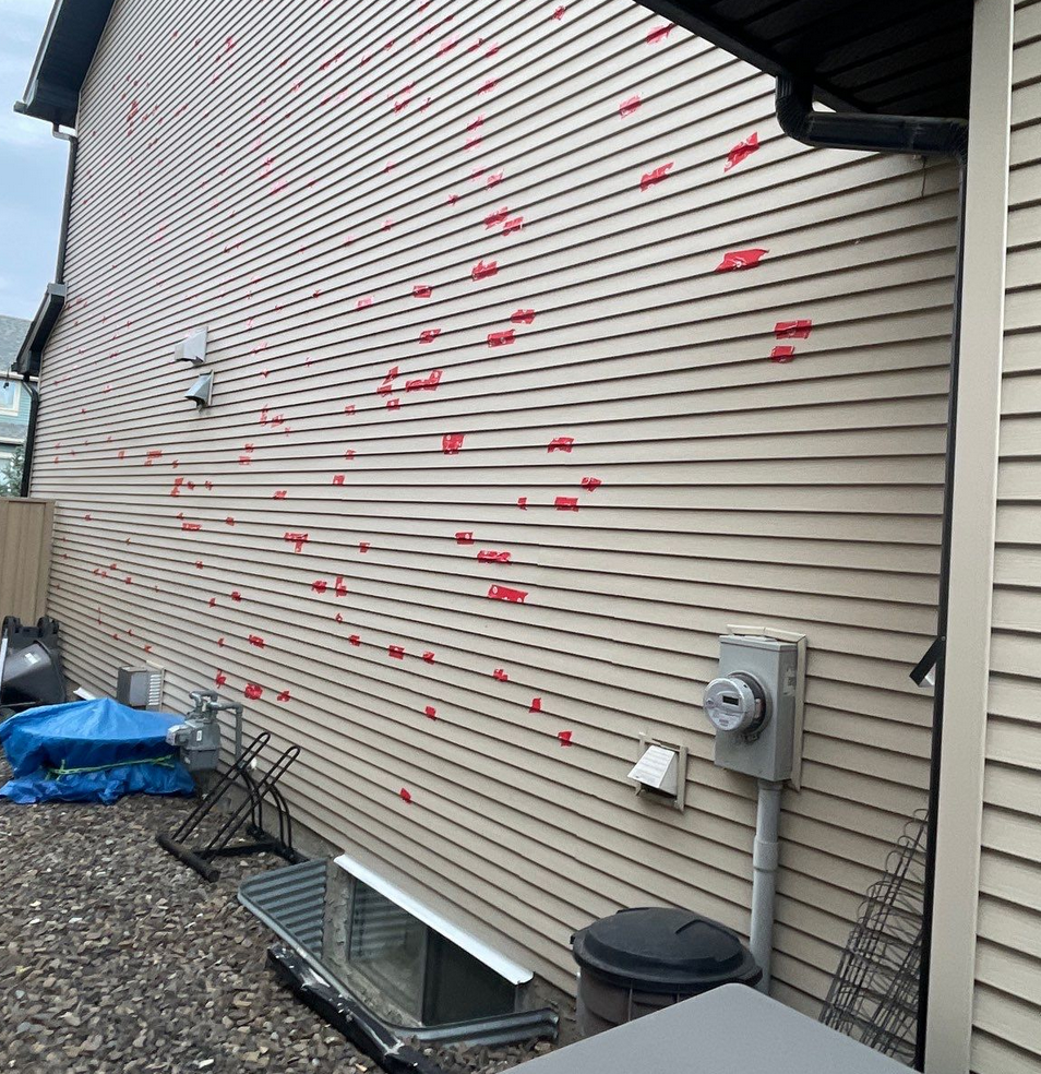 red tape on vinyl siding cracks from hail