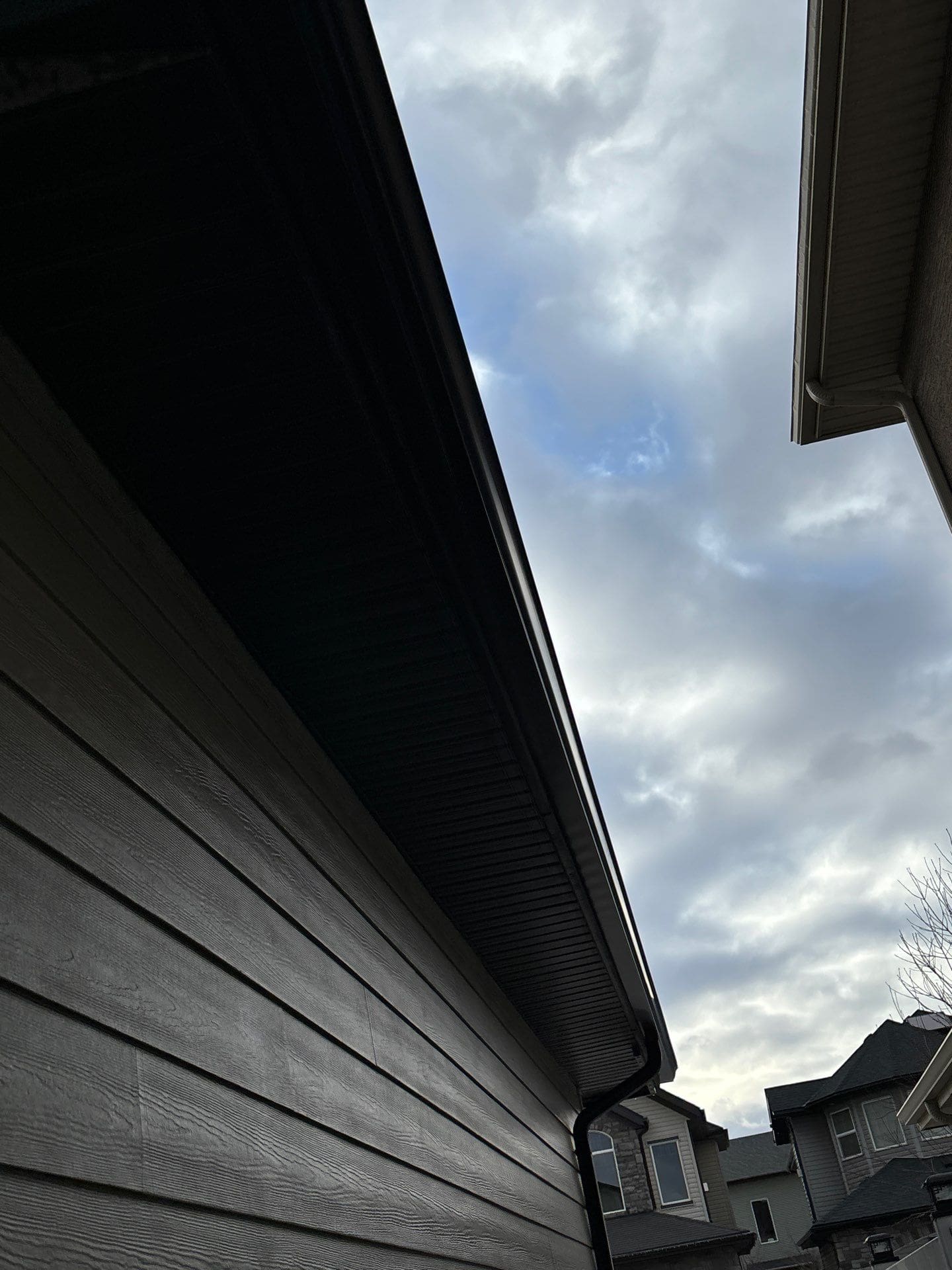 newly installed eaves and downpipes newly installed black eaves and downpipe at Sage Valley Cove NW, Calgary